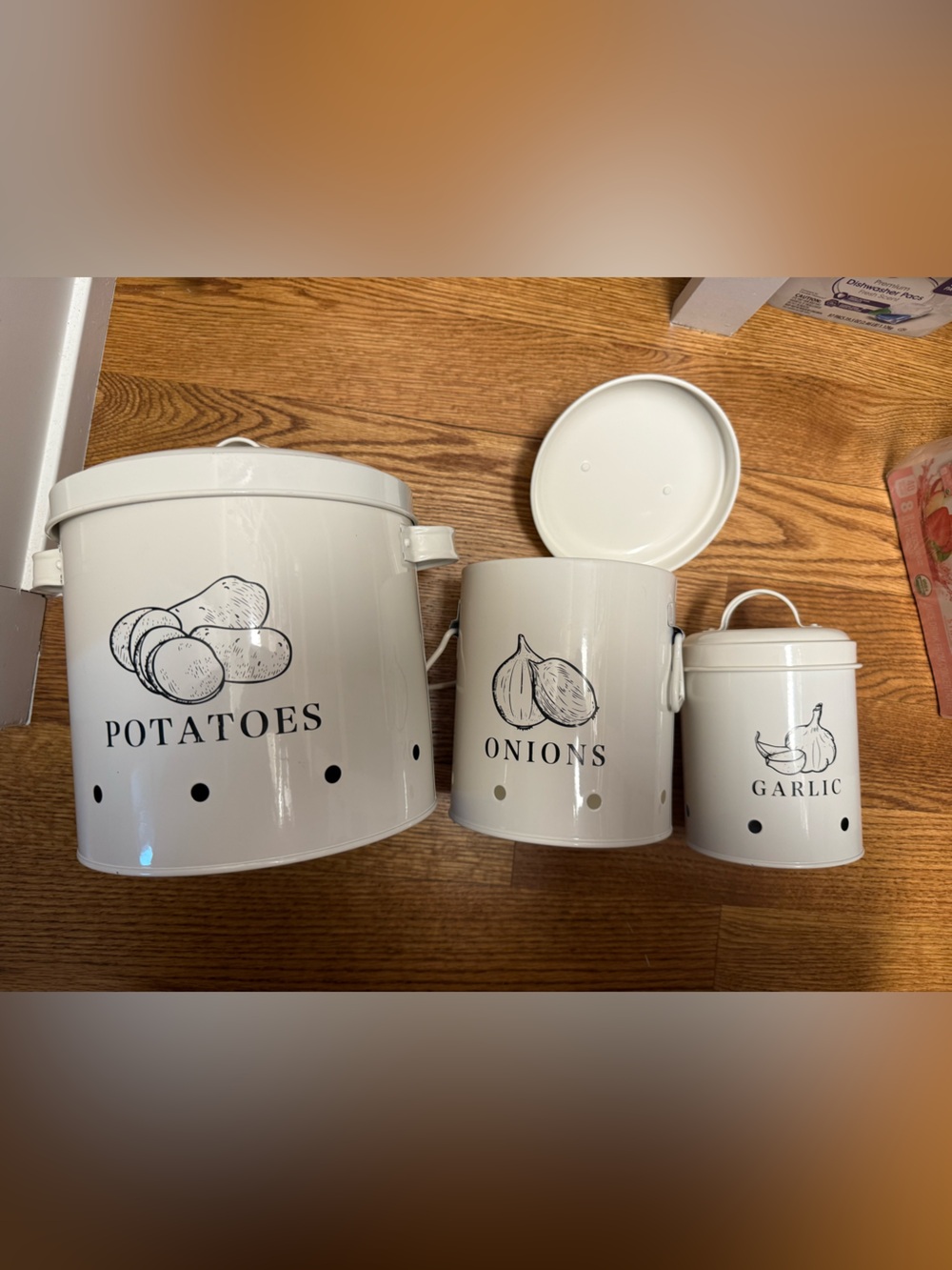 White metal farmhouse-style potato, onion, and garlic storage canisters